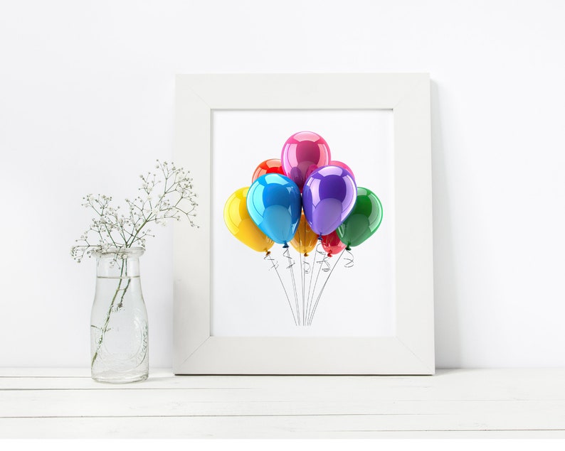 May include: A white framed print featuring a cluster of colorful balloons. The balloons are in shades of red, pink, purple, blue, yellow, and green. The image is set against a white background, with a vase of flowers on the left.