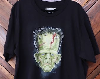 May include: Black t-shirt with a green and red illustration of Frankenstein's monster on the front. The shirt has the text "FUNKYMONKEY" on the tag.