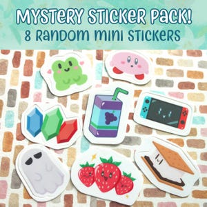 May include: A mystery sticker pack containing 8 random mini stickers featuring colorful illustrations of a green frog, a pink character, blue, green, and red gems, a purple juice box, a handheld gaming console, a ghost, strawberries, and a s'more.