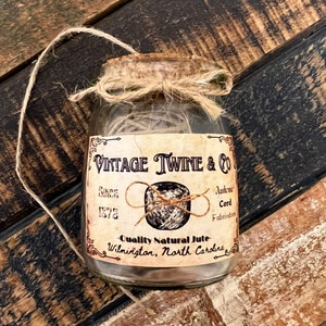 May include: A glass jar filled with twine, tied with twine and a label that reads "Vintage Twine & Co. Since 1872. Authentic Cord Fabrications. Quality Natural Jute. Wilmington, North Carolina."