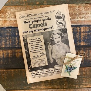 May include: A vintage advertisement for Camel cigarettes featuring a woman holding a cigarette and the text "How MILD can a cigarette be?" and "More people smoke Camels than any other cigarette!"