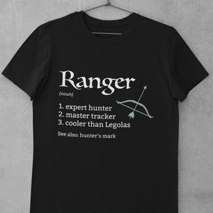 May include: Black t-shirt with white text that reads "Ranger (noun) 1. expert hunter 2. master tracker 3. cooler than Legolas See also: hunter's mark" and a green and white illustration of a bow and arrow.