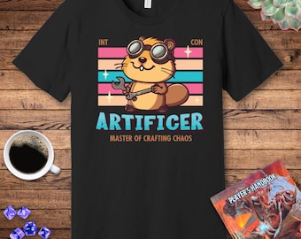 May include: Black t-shirt with a cartoon beaver wearing goggles and holding a wrench. The text "INT CON ARTIFICER MASTER OF CRAFTING CHAOS" is printed on the shirt.