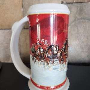 May include: A set of three ceramic mugs with a speckled, matte finish. The mugs are in shades of cream, light gray, and dark gray. Each mug has a simple, minimalist design, perfect for coffee or tea.