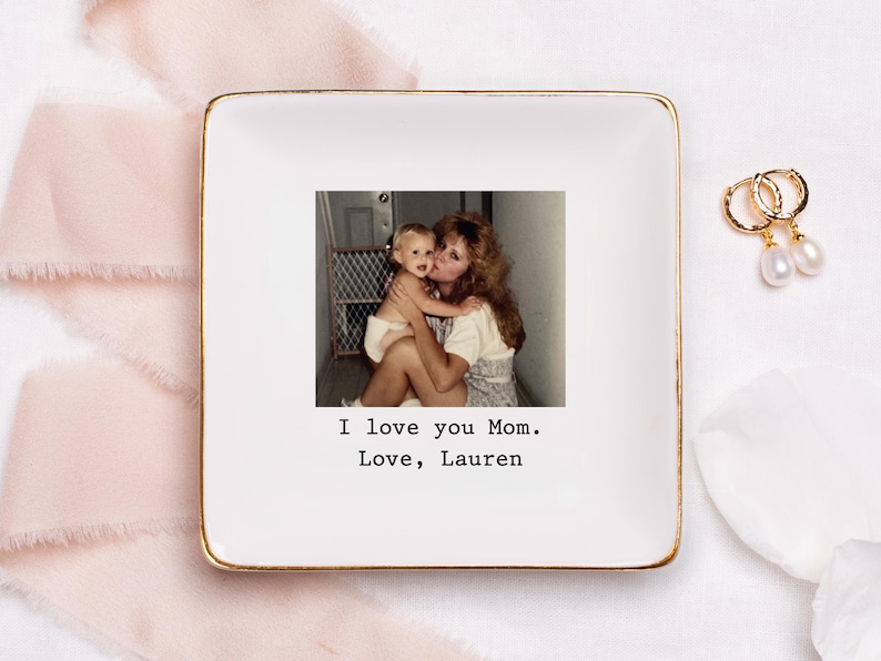 A white trinket tray with a photo and black text on it