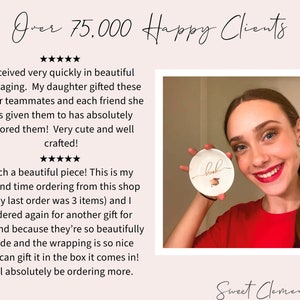 May include: A customer review for a shop called "Sweet Clementines" with a photo of a young woman holding a white ceramic trinket dish with the word "brook" written in gold cursive. The dish has a small gold graduation cap design. The review states that the customer is very happy with the product and the shop.