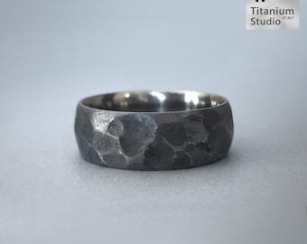 May include: A dark gray titanium ring with a hammered, textured surface. The ring is labeled "Moon Rock Ring".