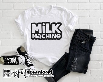 May include: White t-shirt with black text that says "MILK MACHINE". The shirt is laying on a white brick background with a pair of dark blue jeans and black sneakers.