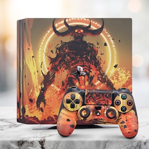 May include: A PlayStation 4 console and controller with a custom skin featuring a fiery demon with horns and glowing red eyes. The demon is surrounded by a circle of runes and flames.