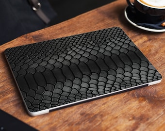 May include: Black laptop skin with a textured snake skin pattern.