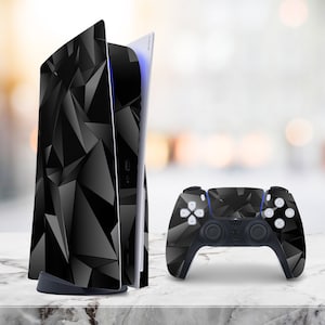 May include: A black and gray geometric design covers a video game console and controller. The console is upright, with a sleek, modern design. The controller is positioned in front of the console, with the same geometric pattern.