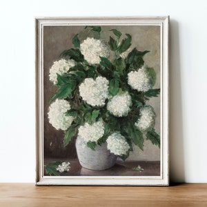 May include: A vintage painting of a white flower bouquet in a white vase. The flowers are arranged in a cluster and have green leaves. The background is a muted brown color.