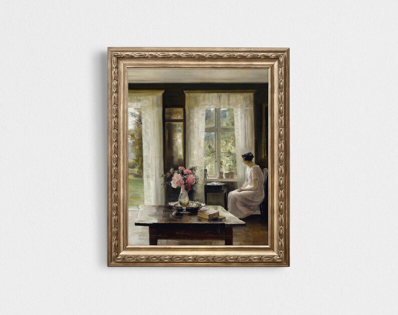 May include: A painting of a woman sitting by a window in a room with a table and flowers. The woman is wearing a white dress and looking out the window. The room is decorated with white curtains and a vase of pink flowers.