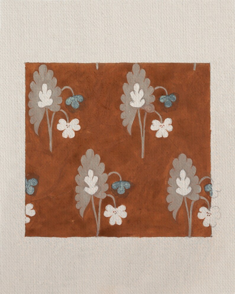 May include: A brown background with a repeating pattern of white and gray stylized flowers. The flowers have a blue center and are arranged in a symmetrical pattern.