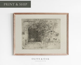 May include: A black and white vintage print of a street scene with people sitting at a table under a tree. The print is framed in a light wood frame.