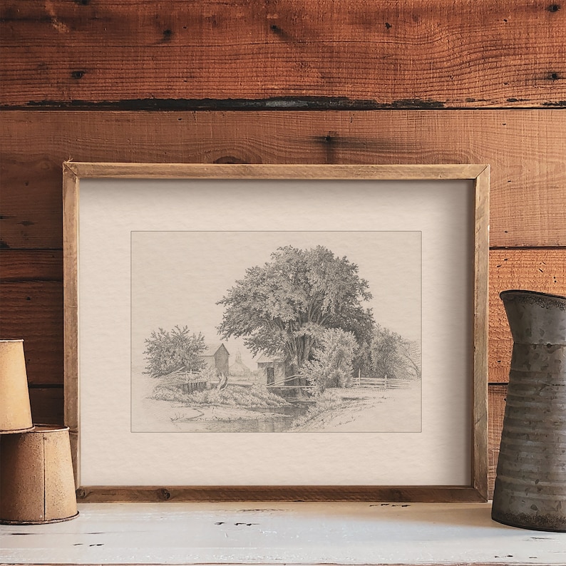 May include: A framed black and white pencil drawing of a country scene with a house, trees, and a fence. The drawing is on a cream-colored background.