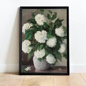 May include: A framed painting of a white hydrangea bouquet in a gray vase. The painting is done in a painterly style with visible brushstrokes.