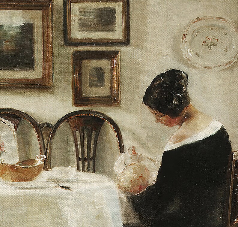May include: An oil painting shows a woman in a black dress, seated at a table, holding a baby. The table is set with a white tablecloth, a bowl, and a cup. Framed pictures and a plate hang on the wall.