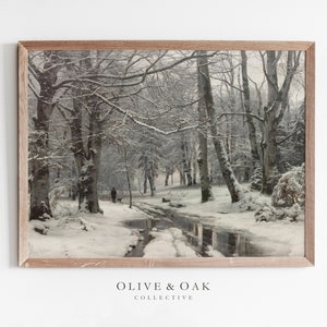 May include: A framed print of a snowy forest scene with a stream running through it. The trees are covered in snow and the ground is white. A single figure walks in the distance.