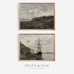 May include: Two framed vintage landscape paintings. The top painting depicts a coastal scene with a cloudy sky. The bottom painting shows a tall ship docked near a rocky shore. The frames are light brown. The text "OLIVE & OAK COLLECTIVE" is at the bottom.