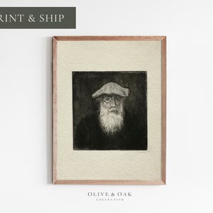 May include: Black and white portrait print of a man with a beard and glasses wearing a hat. The print is framed in a light wood frame.