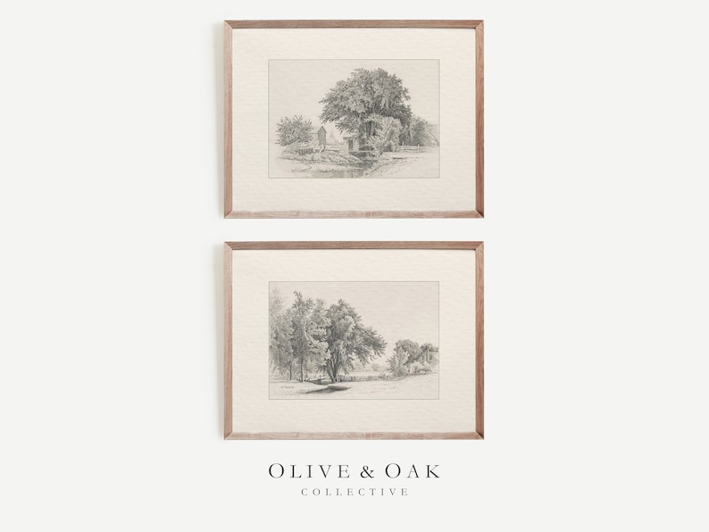May include: A set of two framed black and white pencil drawings of landscapes with trees and houses. The drawings are in a simple, minimalist style. The frames are a light wood color.