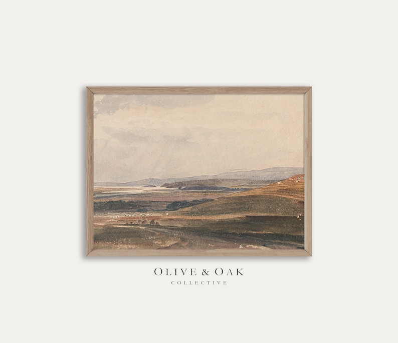 May include: A framed watercolor painting of a landscape with rolling hills and a distant body of water. The sky is a soft blue with wispy clouds. The colors are muted and earthy, with shades of brown, green, and blue.