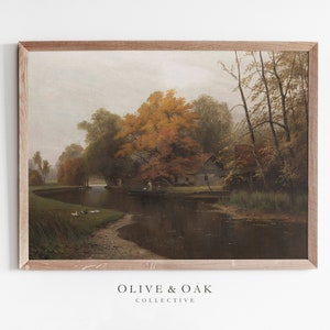Puede incluir: Una pintura enmarcada que representa una escena de paisaje con un r&iacute;o, &aacute;rboles y una peque&ntilde;a casa. Los &aacute;rboles est&aacute;n en colores oto&ntilde;ales, con tonos de amarillo, naranja y rojo. El r&iacute;o es tranquilo y reflectante, y el cielo est&aacute; nublado.