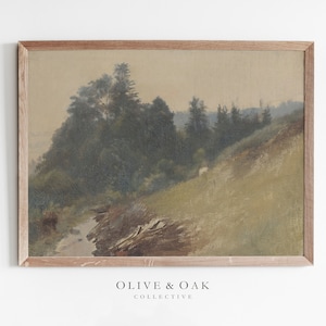 May include: A framed painting of a forest scene with a stream running through it. The painting is done in muted tones of green, brown, and beige. The frame is a simple, light brown wood.