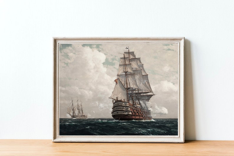 May include: A framed painting of a large sailing ship with white sails and a brown hull, sailing on a cloudy day. A smaller ship is visible in the distance.