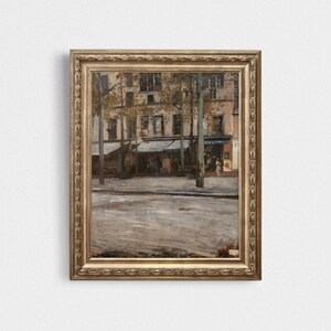 May include: A framed painting depicting a street scene in Paris, France. The painting features a street lined with buildings and trees, with a cafe on the right side of the image. The cafe has a sign that reads "Cafe du Commerce".