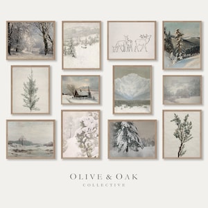 May include: A collection of framed winter landscape art prints. The prints feature snowy scenes of trees, mountains, and cabins in muted tones. The Olive & Oak Collective logo is at the bottom.