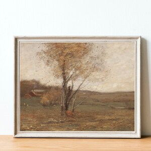 May include: A framed painting of a landscape with a single tree in the center. The tree has brown branches and yellow leaves. The background is a hazy, light brown color with a small house in the distance.