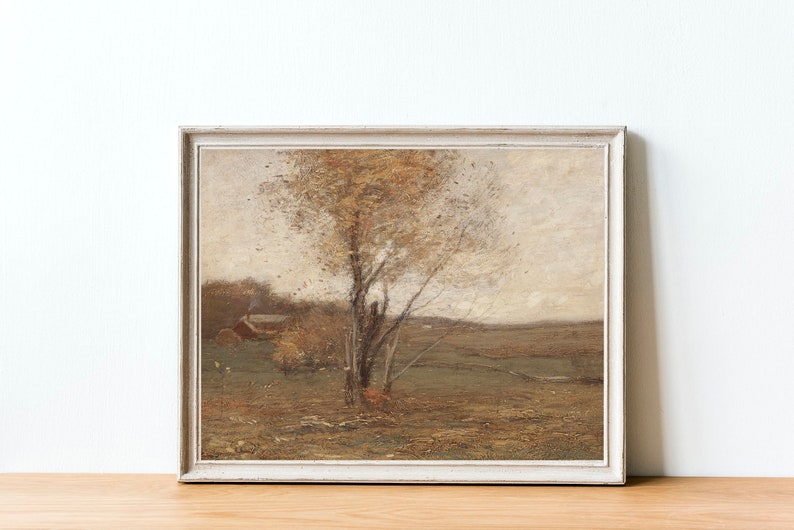 May include: A framed painting of a landscape with a single tree in the center. The tree has brown branches and yellow leaves. The background is a hazy, light brown color with a small house in the distance.