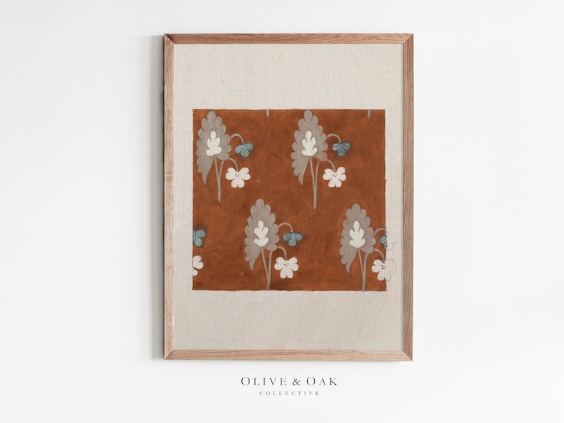 May include: A framed print of a floral pattern on a brown background. The flowers are white and blue with a gray outline. The frame is a light brown wood.