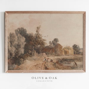 May include: A framed watercolor painting depicting a rural landscape with a farmhouse, trees, and a dirt road. The sky is a soft pink and the trees are a mix of green and brown. The painting is in a light wood frame.