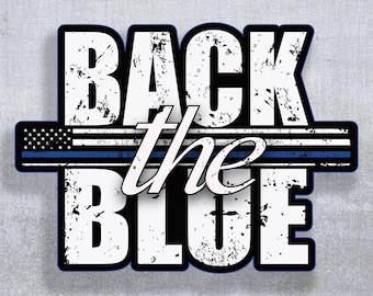May include: A graphic with the words "BACK the BLUE" in white, distressed font. A blue line and American flag design are centered between the words. The image has a black border and a gray background.
