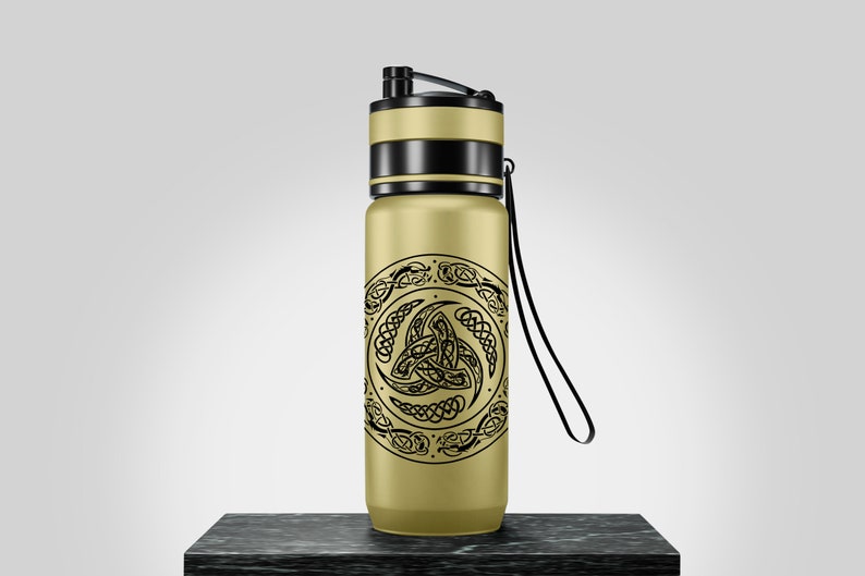 May include: A gold water bottle with a black strap and a black and gold lid. The bottle has a black and white Celtic knot design.