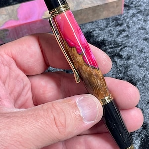 Custom hand-turned pen made of a hybrid of resin and Mallee burl wood.