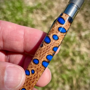 Custom one-off hand-turned click pen made from a Banksia pod cast in acrylic. Stainless steel hardware and German metal mechanism.