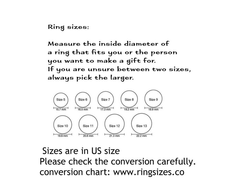 May include: A chart showing ring sizes in US sizes with corresponding inside diameter measurements in millimeters. The chart includes sizes 5 through 13. The text reads "Ring sizes: Measure the inside diameter of a ring that fits you or the person you want to make a gift for. If you are unsure between two sizes, always pick the larger. Sizes are in US size. Please check the conversion carefully. conversion chart: www.ringsizes.co"