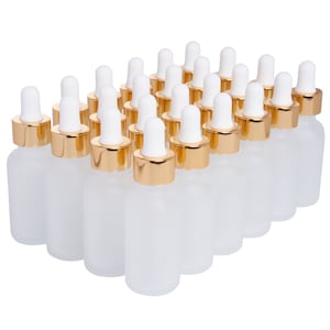 May include: A set of 20 frosted glass bottles with gold caps and droppers. The bottles are arranged in a triangular shape.
