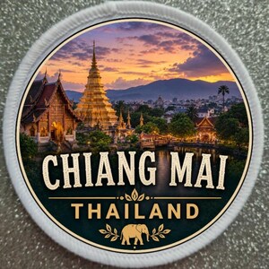 May include: Round patch featuring a scenic view of Chiang Mai, Thailand, with a golden temple and a sunset sky. The text "CHIANG MAI THAILAND" is displayed in a stylized font, with an elephant graphic.
