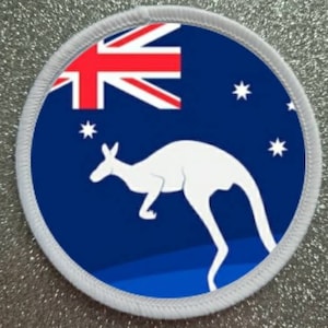 May include: A white kangaroo silhouette on a blue background with a red, white, and blue Australian flag in the upper left corner. There are white stars on the blue background.