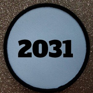 May include: White round fabric patch with a black border and the number 2031 printed in black.
