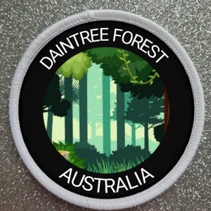 May include: A white and black round patch with the text "DAINTREE FOREST AUSTRALIA" and a green and brown illustration of a forest.