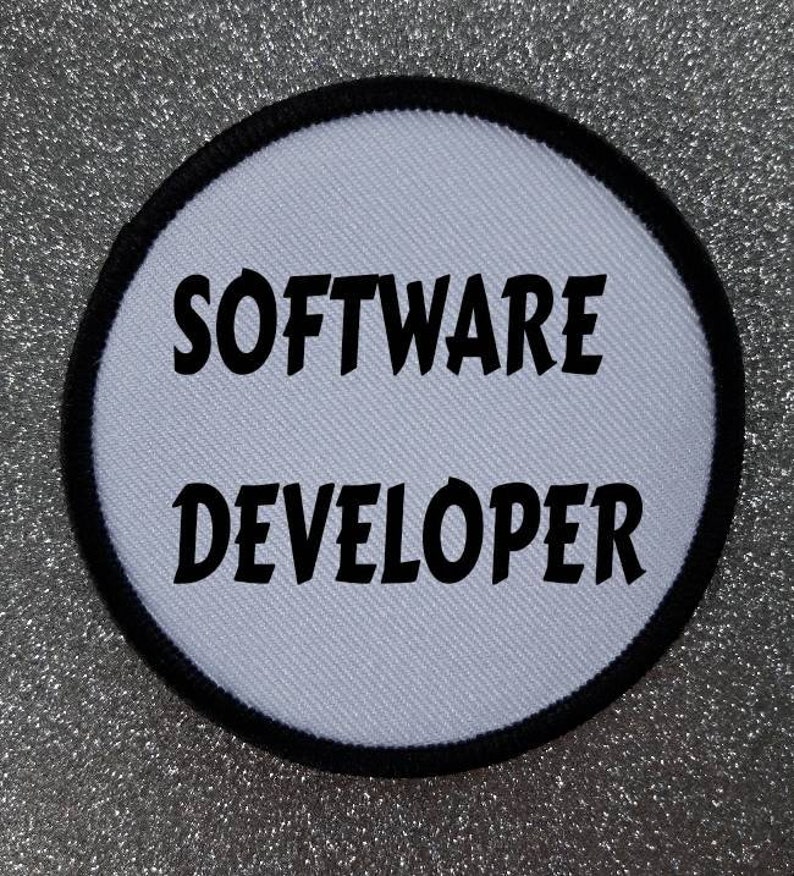 May include: White round patch with black stitching around the edge. The text "SOFTWARE DEVELOPER" is printed in black.