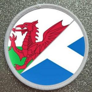 May include: A white circular patch with a red dragon on a green and white background and a blue and white diagonal cross on a white background.