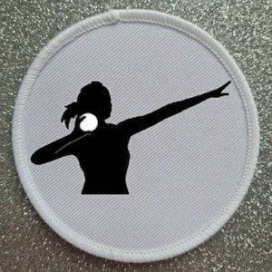 May include: White round patch with a black silhouette of a person throwing a shot put. The person is in a throwing pose with their arm extended and the shot put in their hand.