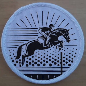 May include: Black and white illustration of a person riding a horse over a jump. The horse is jumping over a fence with a white background and black sun rays.